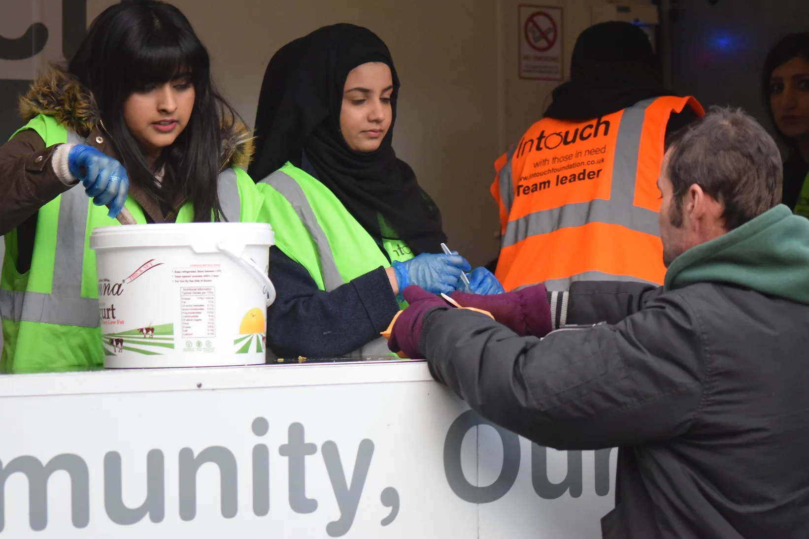 Volunteers handing out freshly cooked chicken Biryani